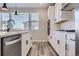 Modern kitchen with white cabinets, quartz countertops, and stainless steel appliances at 9656 Browns Peak Cir, Littleton, CO 80125