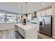 Modern kitchen with white cabinets, quartz counters, and stainless steel appliances at 9656 Browns Peak Cir, Littleton, CO 80125