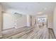 Spacious living area with kitchen and staircase, showcasing light neutral tones at 9656 Browns Peak Cir, Littleton, CO 80125