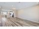 Open living room with kitchen and stairs, featuring wood-look floors at 9656 Browns Peak Cir, Littleton, CO 80125