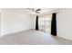 Expansive bedroom featuring carpet, sliding glass doors to a patio, and painted brick wall at 9925 W 20Th Ave # 2, Lakewood, CO 80215