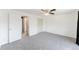 Neutral bedroom featuring carpet, closet, ensuite bathroom, and ceiling fan at 9925 W 20Th Ave # 2, Lakewood, CO 80215