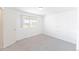 Bright bedroom featuring a window and a painted brick accent wall and neutral carpeting at 9925 W 20Th Ave # 2, Lakewood, CO 80215
