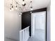 Hallway featuring modern spider light fixture and view to carpeted bedroom at 9925 W 20Th Ave # 2, Lakewood, CO 80215
