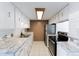 Efficient kitchen with white cabinets, subway tile, and stainless steel appliances at 9925 W 20Th Ave # 2, Lakewood, CO 80215