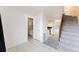 Open living space featuring tile flooring, carpeted stairs, and bathroom at 9925 W 20Th Ave # 2, Lakewood, CO 80215