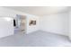 Spacious carpeted living room featuring breakfast bar and white brick accent wall at 9925 W 20Th Ave # 2, Lakewood, CO 80215