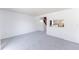 Spacious carpeted living room featuring breakfast bar and white brick accent wall at 9925 W 20Th Ave # 2, Lakewood, CO 80215