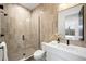 Modern bathroom featuring a glass enclosed shower and a sleek white vanity with dark hardware at 1001 S Adams St, Denver, CO 80209