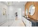 Luxurious bathroom featuring glass shower, wood accent wall, and a double sink vanity at 1001 S Adams St, Denver, CO 80209