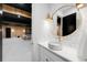Modern bathroom with stylish wood paneling and a sleek marble vessel sink with gold accents at 1001 S Adams St, Denver, CO 80209