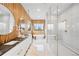 Contemporary bathroom with double vanity, soaking tub, and a glass-enclosed shower at 1001 S Adams St, Denver, CO 80209