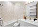 Bright bathroom showcasing cream tiled walls, soaking tub, a modern white vanity, and matte black hardware at 1001 S Adams St, Denver, CO 80209
