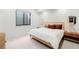 Minimalist bedroom featuring a platform bed, modern lamps, and natural light from the window at 1001 S Adams St, Denver, CO 80209