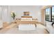 Bright bedroom featuring light hardwood floors, a neutral color palette, and modern furniture at 1001 S Adams St, Denver, CO 80209