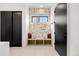 Inviting entryway with stylish wallpaper, bench seating, and a modern black door at 1001 S Adams St, Denver, CO 80209
