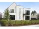 Striking modern home featuring a bright white facade, black framed windows and a minimalist landscape at 1001 S Adams St, Denver, CO 80209