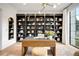 Stylish home office features a large built-in bookcase, modern desk, and neutral color palette at 1001 S Adams St, Denver, CO 80209