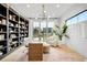 Sunlit home office with custom built-in bookcase, modern desk, and plush seating at 1001 S Adams St, Denver, CO 80209