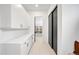 Walk-in pantry featuring white cabinetry with gold hardware and a sliding black door at 1001 S Adams St, Denver, CO 80209