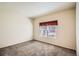 Neutral bedroom featuring a window with blinds and decorative valance, providing a serene and comfortable space at 4385 S Balsam St # 6-103, Littleton, CO 80123