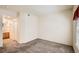 A spacious bedroom shows neutral carpeting and paint with a window and view to the bathroom at 4385 S Balsam St # 6-103, Littleton, CO 80123