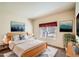Comfortable bedroom featuring a wooden bed frame, soft blue accents, and decorative wall art at 4385 S Balsam St # 6-103, Littleton, CO 80123