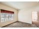 Bright bedroom featuring neutral walls, a window with valance, and a view to a large closet at 4385 S Balsam St # 6-103, Littleton, CO 80123