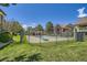 Community pool surrounded by green grass and mature landscaping at 4385 S Balsam St # 6-103, Littleton, CO 80123