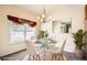 Sunlit dining room with modern table, stylish chairs, elegant chandelier, and decorative mirror at 4385 S Balsam St # 6-103, Littleton, CO 80123