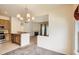 A view of the kitchen with oak cabinets and stainless steel appliances, which opens into the dining and living rooms at 4385 S Balsam St # 6-103, Littleton, CO 80123