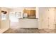 Open-concept view into the kitchen, showing stainless steel appliances and hardwood cabinets at 4385 S Balsam St # 6-103, Littleton, CO 80123