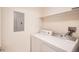 Convenient laundry area with side-by-side washer and dryer, and utility shelf at 4385 S Balsam St # 6-103, Littleton, CO 80123