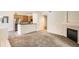 Open concept living space with kitchen, fireplace, and new carpet at 4385 S Balsam St # 6-103, Littleton, CO 80123