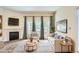 Bright living room with fireplace, large windows, comfortable seating, and stylish decor at 4385 S Balsam St # 6-103, Littleton, CO 80123