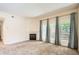Bright living room with a cozy fireplace and ample natural light from large windows at 4385 S Balsam St # 6-103, Littleton, CO 80123