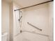 Updated shower stall featuring white subway tiles, safety rails and a handheld shower head at 4385 S Balsam St # 6-103, Littleton, CO 80123
