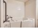 Close-up of accessible walk-in bathtub with safety grab bar and tile surround at 4385 S Balsam St # 6-103, Littleton, CO 80123