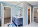 A bathroom featuring a double vanity and blue accents at 13504 E Asbury Dr, Aurora, CO 80014