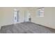 A bright bedroom featuring gray carpet, fresh paint, and natural light at 13504 E Asbury Dr, Aurora, CO 80014