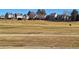 View of community with green grass, golf course and other homes at 13504 E Asbury Dr, Aurora, CO 80014