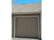 Attached single-car garage with a taupe door and light trim, number 146 above the door at 13504 E Asbury Dr, Aurora, CO 80014