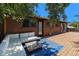 Back deck with outdoor seating area features direct access to the brick home's interior at 15 Pawnee Dr, Boulder, CO 80303
