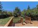 Spacious backyard featuring mountain views from a large wooden deck and fenced lawn at 15 Pawnee Dr, Boulder, CO 80303