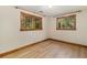 Bright bedroom features hardwood floors, white walls, and natural wooden trim and window frames at 15 Pawnee Dr, Boulder, CO 80303