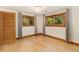 Bright bedroom boasts hardwood floors, wooden trim windows and door, and decorative ceiling light at 15 Pawnee Dr, Boulder, CO 80303