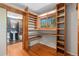 View into a closet with open shelving and a peek into the elegant bathroom at 15 Pawnee Dr, Boulder, CO 80303