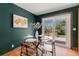 Dining area features a glass table, wood floors and a sliding door with mountain view at 15 Pawnee Dr, Boulder, CO 80303
