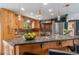 Charming kitchen boasts custom wood cabinets, copper backsplash, island and stainless steel appliances at 15 Pawnee Dr, Boulder, CO 80303
