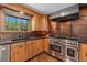 Beautiful kitchen with a stainless steel oven and wood cabinets for storage and style at 15 Pawnee Dr, Boulder, CO 80303